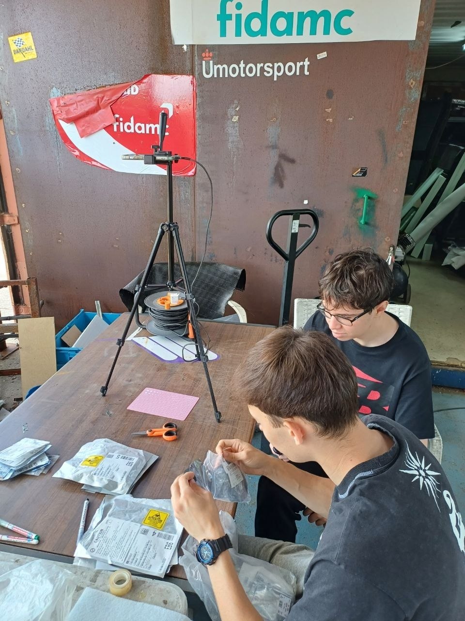The team photographing components on a tripod rig